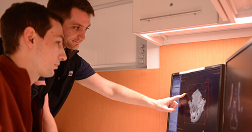 Dr. Jonathan Wood consults with radiologist Dr. Jonathan Nevins (foreground) about a 3D rendering of a CT image.