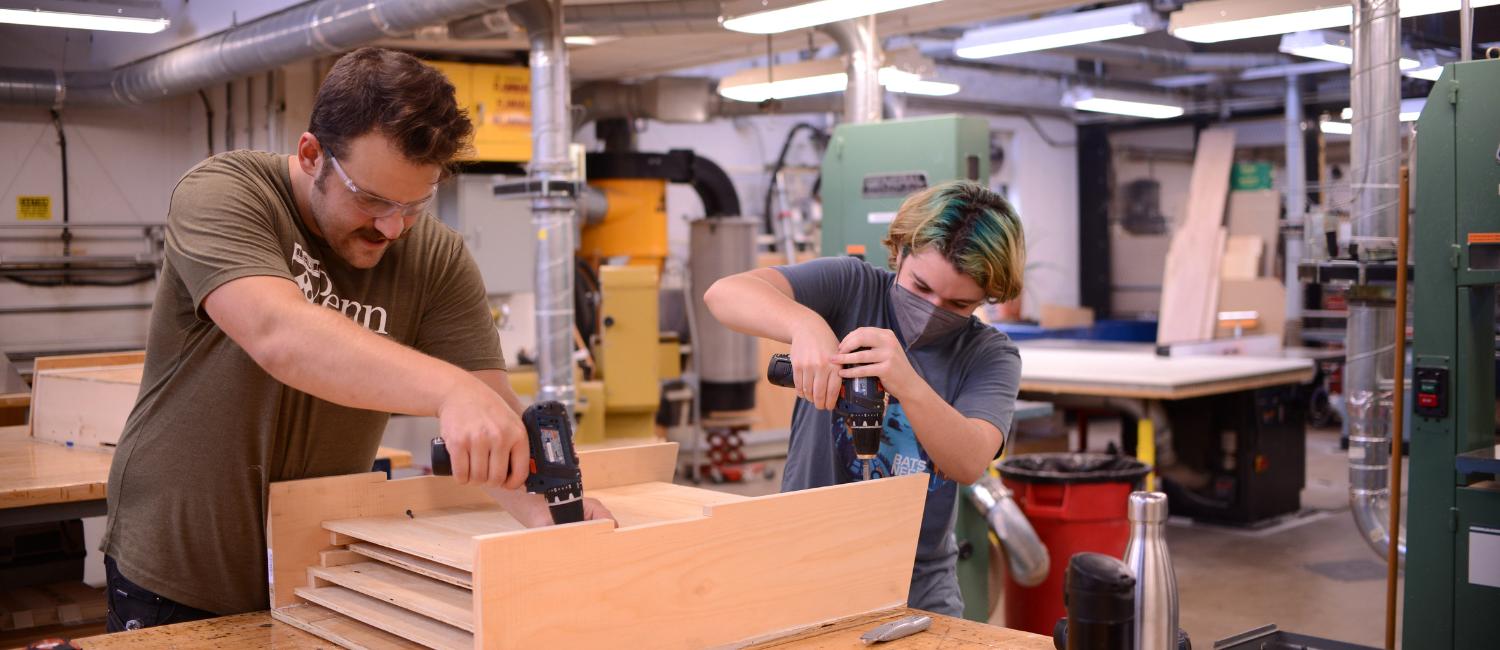 People using drills to build a bat box People using drills to build a bat box