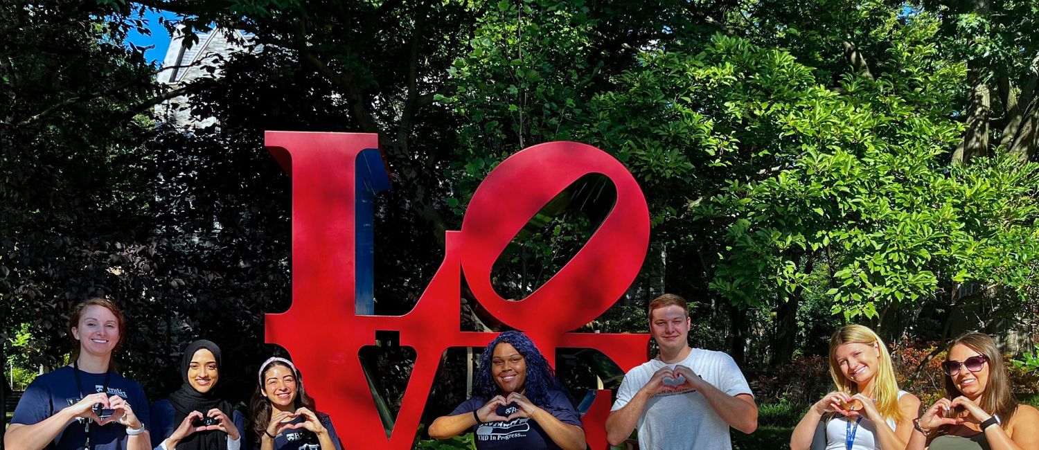 Students standing in front of Love Statue