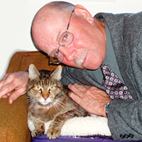 Photo of a man posing with a cat