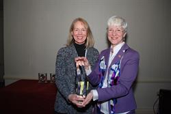 Dean Joan Hendricks (r) presents Dr. Joanna Bassert with the Alumni Achievement Award.