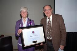 Dean Joan Hendricks presents Dr. Theodore Robinson with the Alumni Award of Merit.
