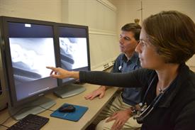 Dr. Amy Johnson looks at radiographs with Dr. Ray Sweeney.