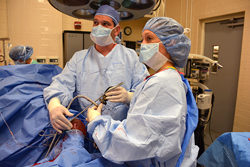 Dr. David Levine (l) performs surgery on Liam's leg