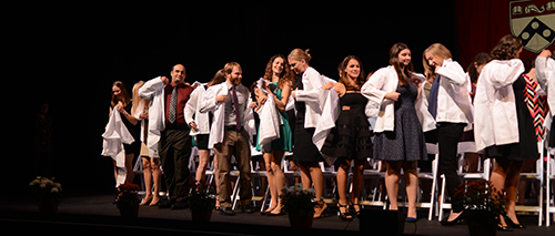 The Class of 2017 dons their white coats for the first time.