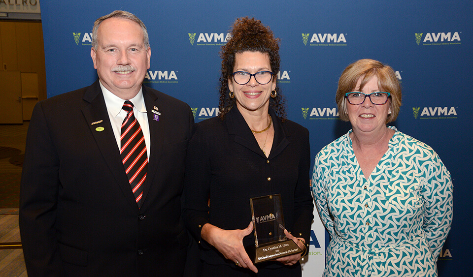 From left, Dr. Michael J. Topper, AVMA President; Dr. Cynthia Otto; and Dr. Linda Lord