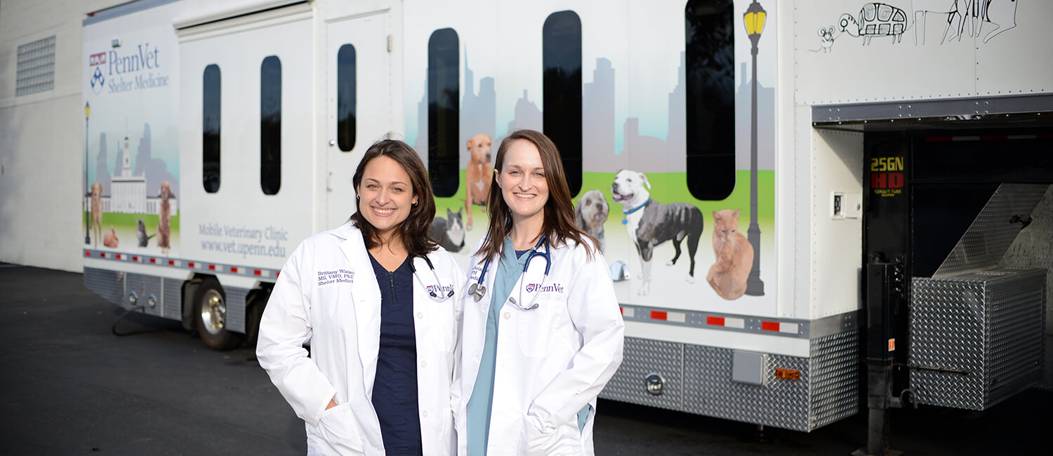 Dr. Brittany Watson and Dr. Chelsea Reinhard stand in front of the new shelter medicine mobile clinic.