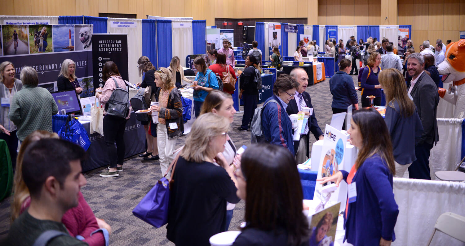 Attendees visit the exhibitor booths.