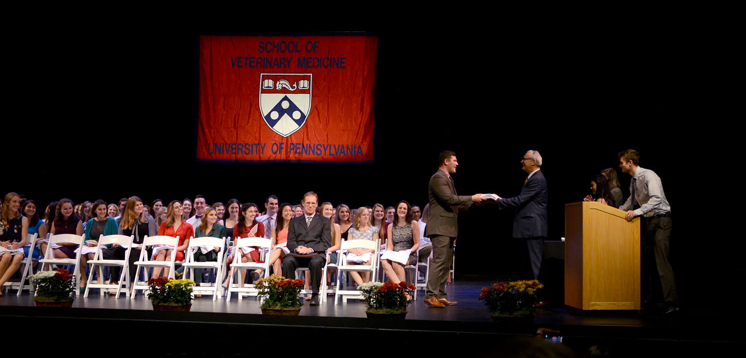 The Class of 2021 receives their white coats from Dean Andrew Hoffman