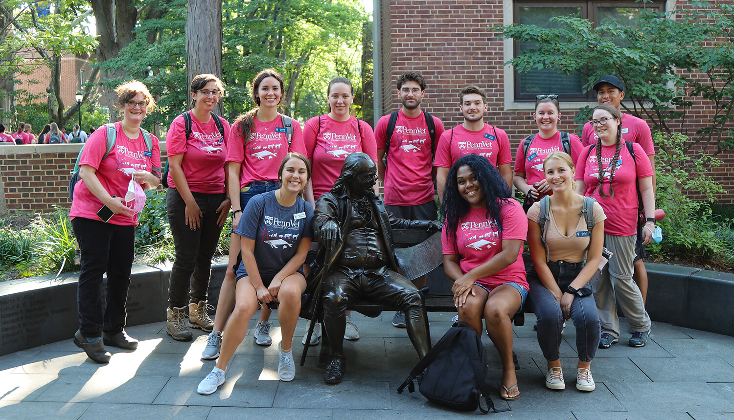 Members of V'25 visit the Benjamin Franklin statue during their tour of Penn's campus.