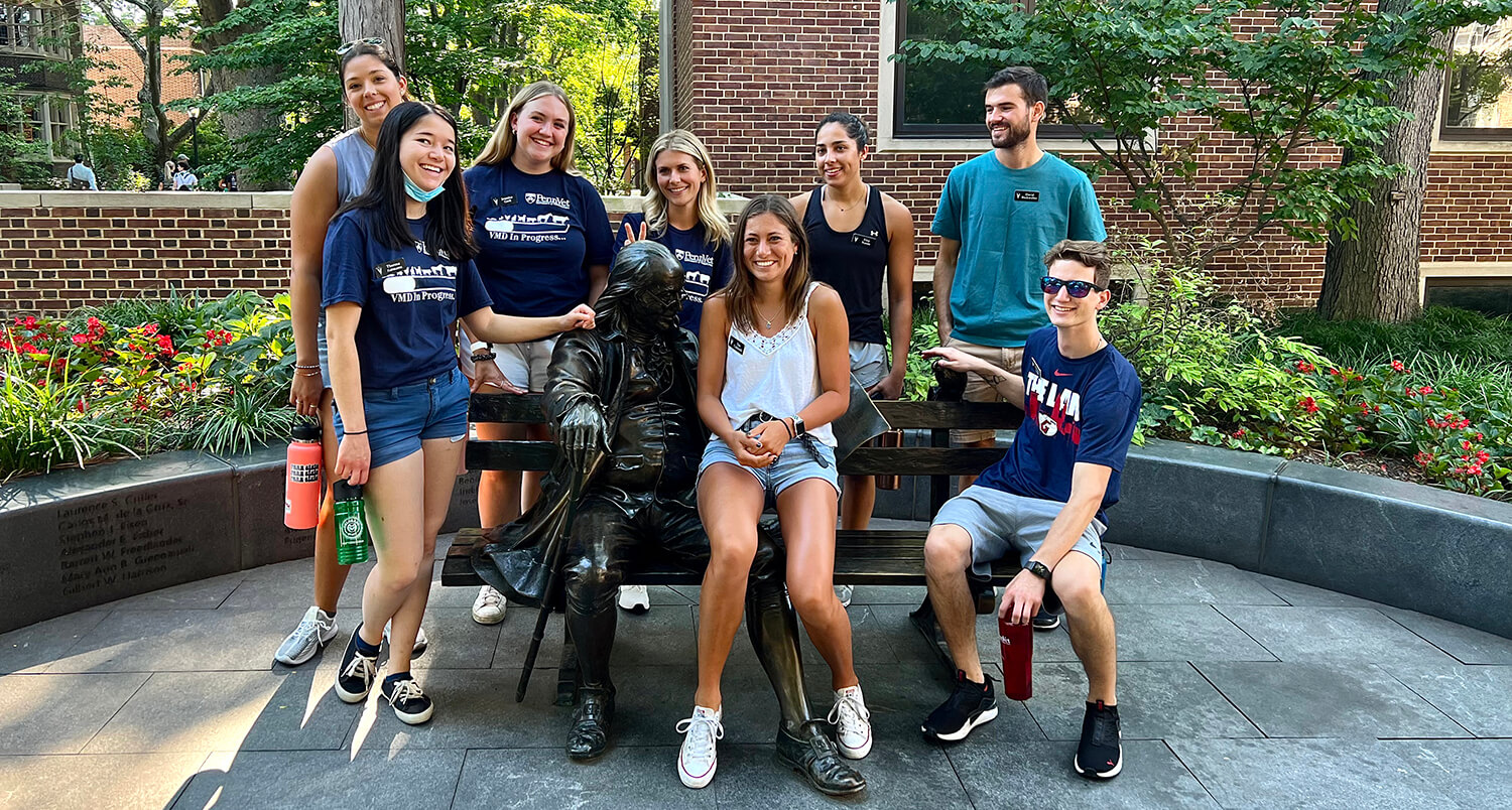 Members of V'26 visit the Benjamin Franklin statue during their tour of Penn's campus.
