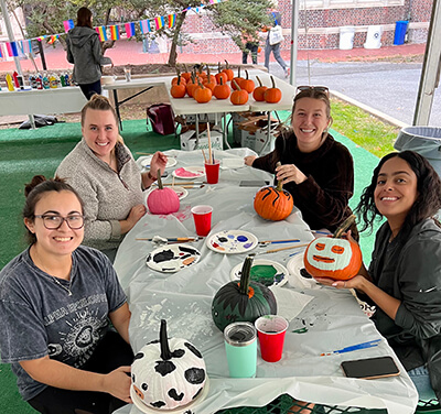 Photo of students painting pumpkins.