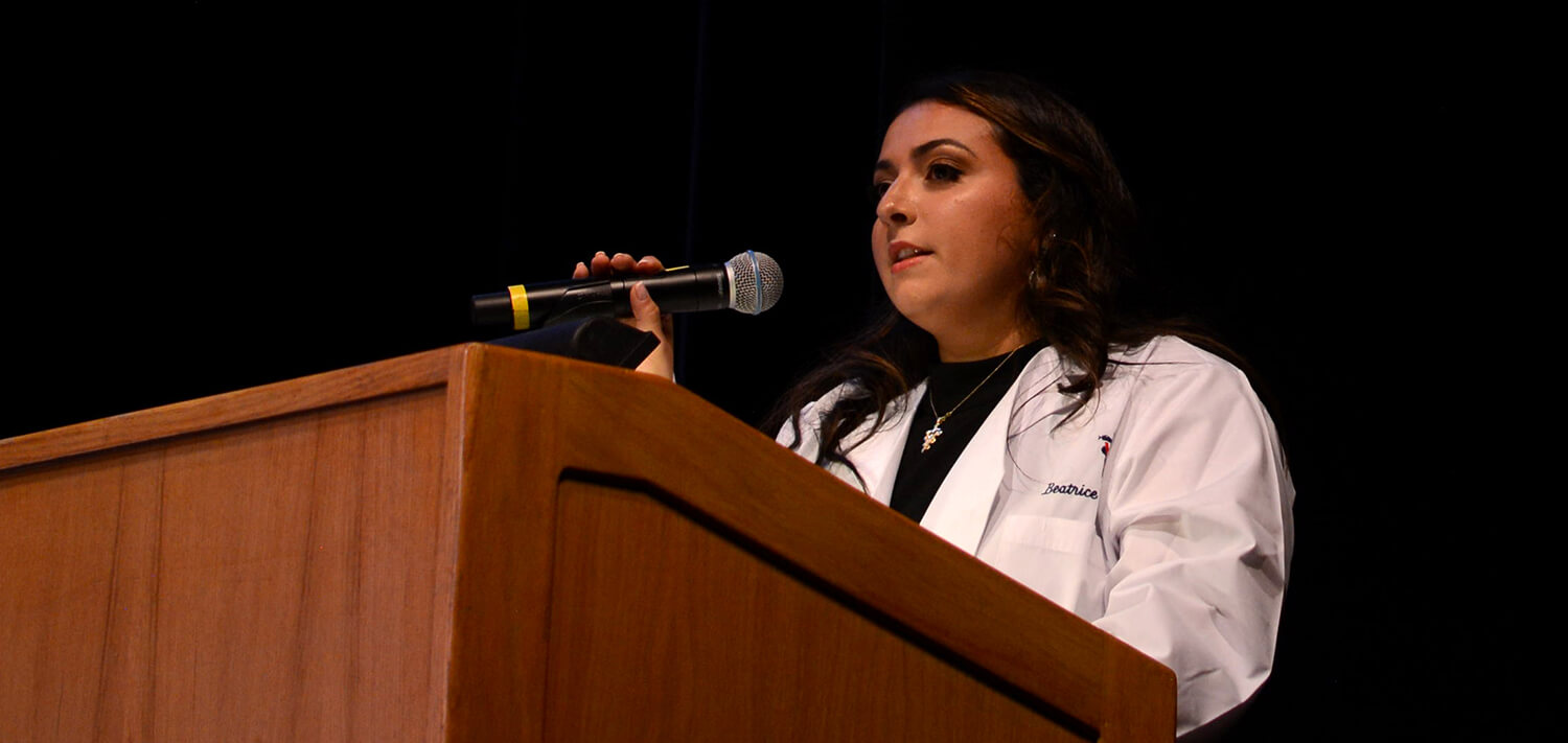 Photo of student speaking at podium