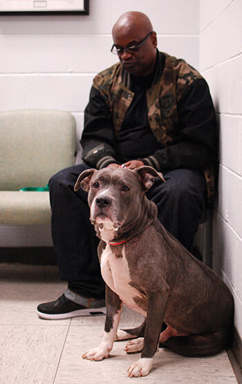 Leroy Buchanan sits with Blue during Blue's check-up