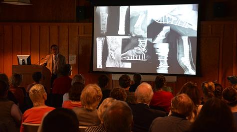 Dr. Dean Richardson speaks before a packed house at the First Tuesday Lecture