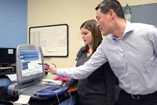 Dr. Danielle Laughlin and Dr. Mark Oyama check the power output on Jake's pacemaker.