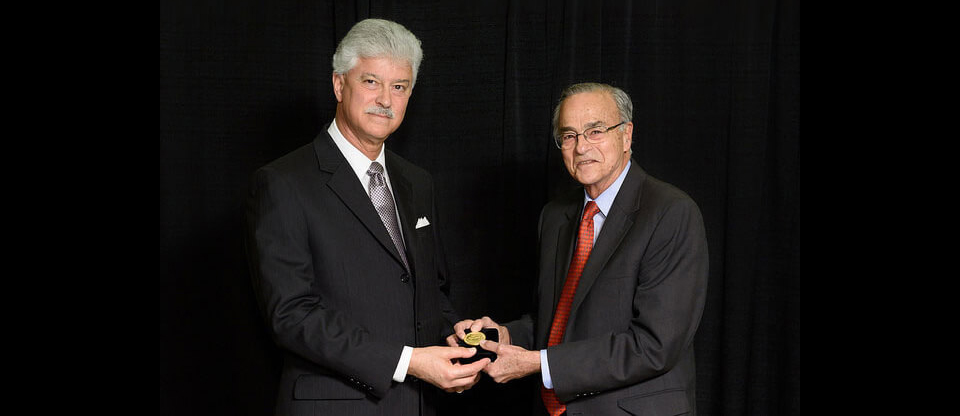 At right, Dr. Gustavo Aguirre receives the Proctor Medal from ARVO Board Trustee Steven J. Fliesler
