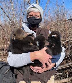 Dr. Erica Miller with cubs, Wildlife Futures Team