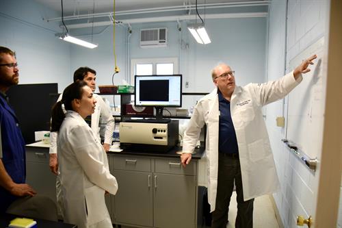 Dr. Gary Althouse explains key concepts to students during a hands-on lab.