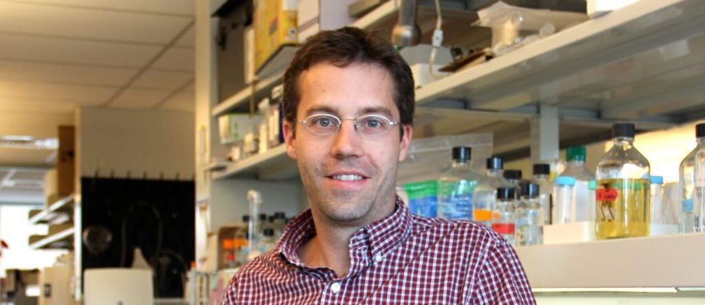 Christopher J. Lengner standing in his lab.