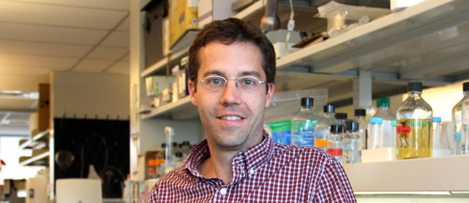Christopher J. Lengner standing in his lab.