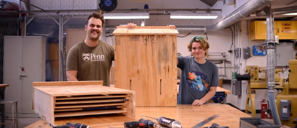 Two people standing in a workshop.