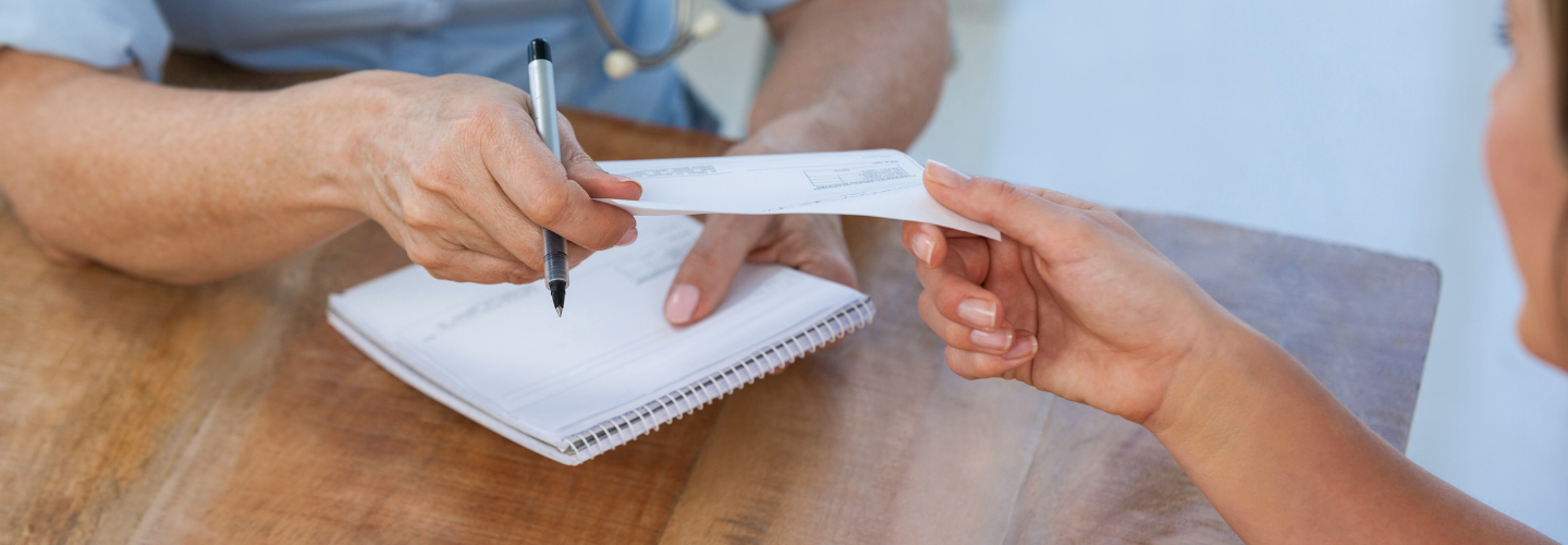 Person with a pen taking a piece of paper.