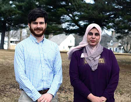 Faculty standing in corn field