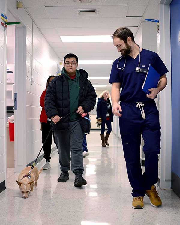 dog walking in hospital hallway