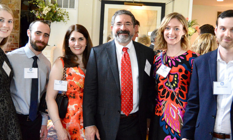 A group of people in nice clothes at an event