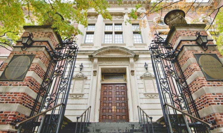 the entrance to a building with ornate iron gates