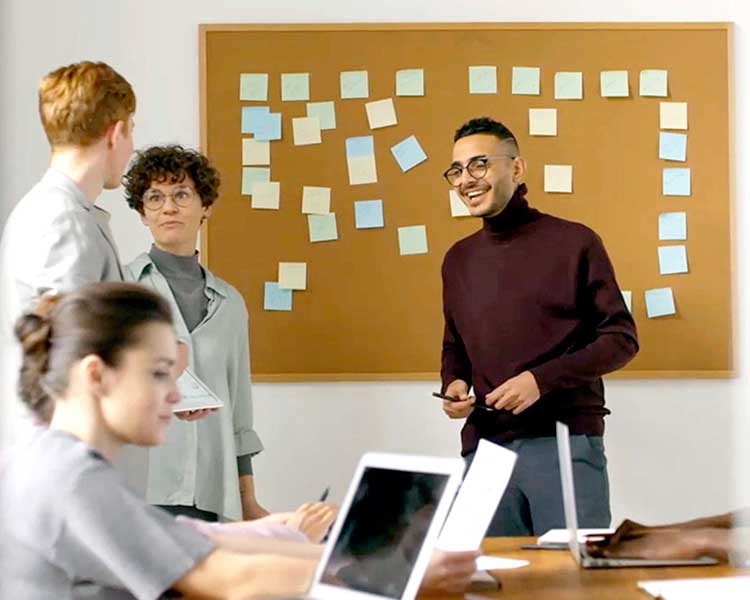 two people talking at a desk, using their hands