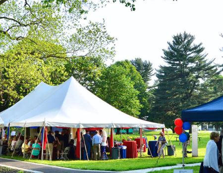 a group of people under tents in a park