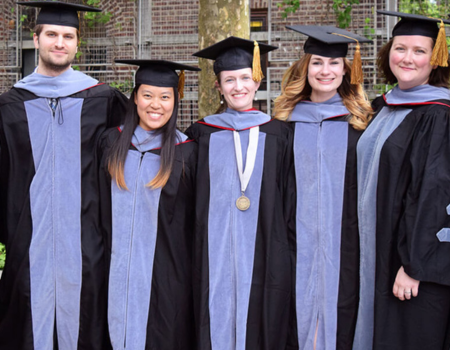 a group of graduates posing for a photo