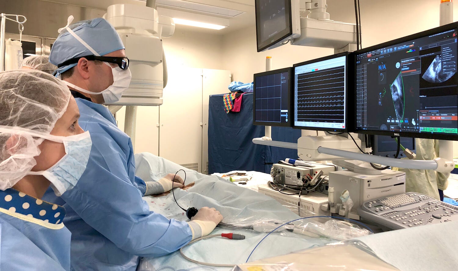 Clinicians looking at a computer screen.