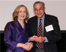 Two people with their arms wrapped arm and arm at an event.