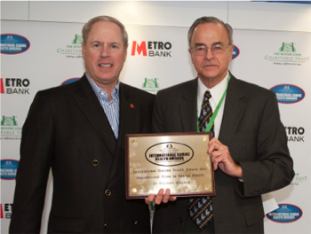 Two people standing with a plaque