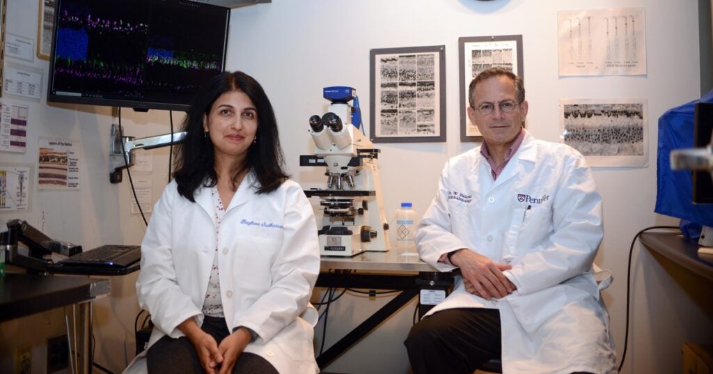 Raghavi Sudharsan and William Beltran sitting in a lab.