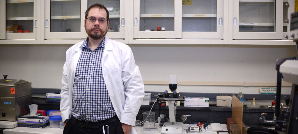Eoin Whelan, PhD standing in a lab.