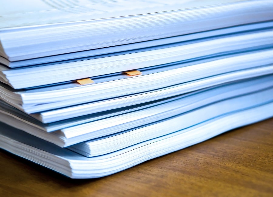 A stack of publications on a table.