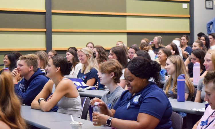 New students sit in a lecture hall.