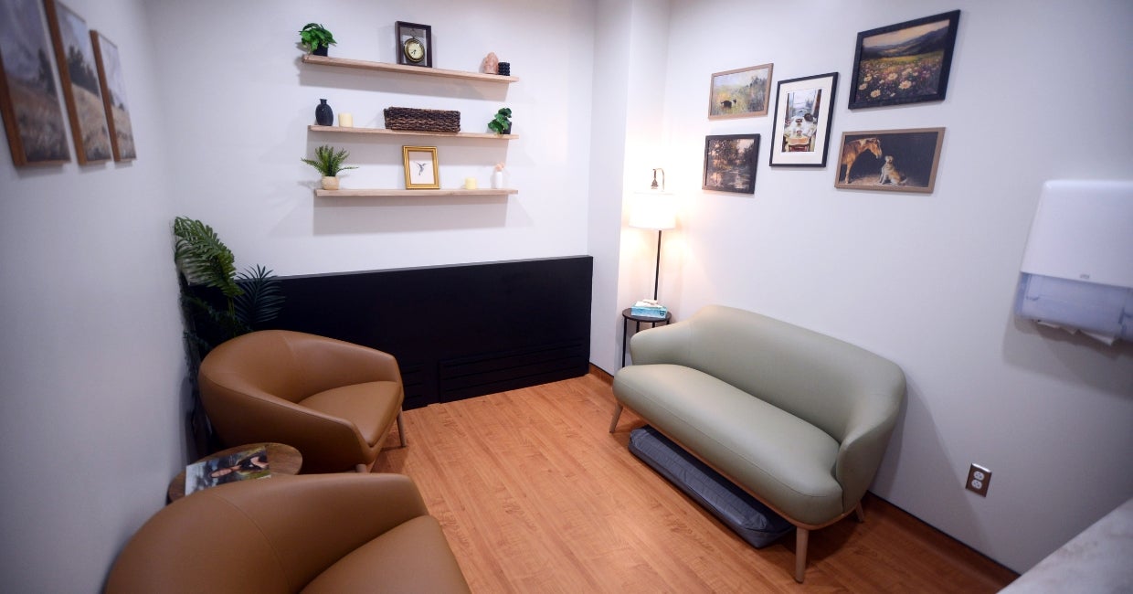 a room with two chairs and pictures on the wall