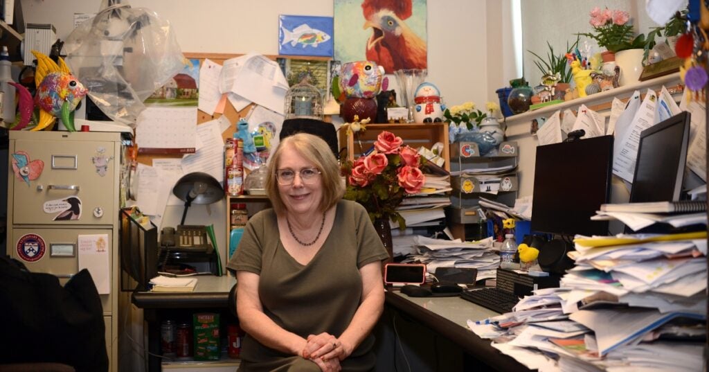 A woman sitting in her office.