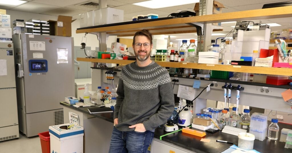 a person standing in a laboratory with lots of equipment