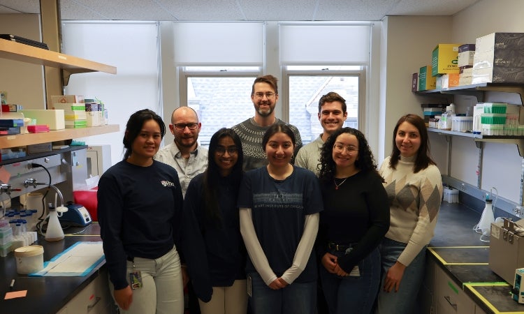a group of people posing for a photo in a laboratory