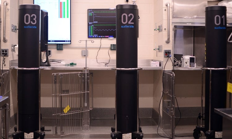 a room with several machines in it and a monitor on the wall